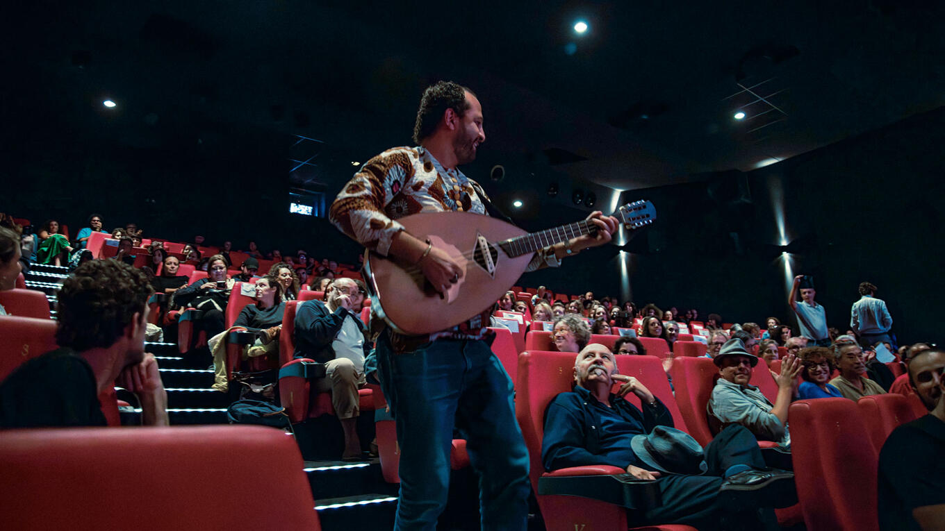 Kader Denednia surprises the audience with a live mandole performance during the end credits of Sunny Side Up.