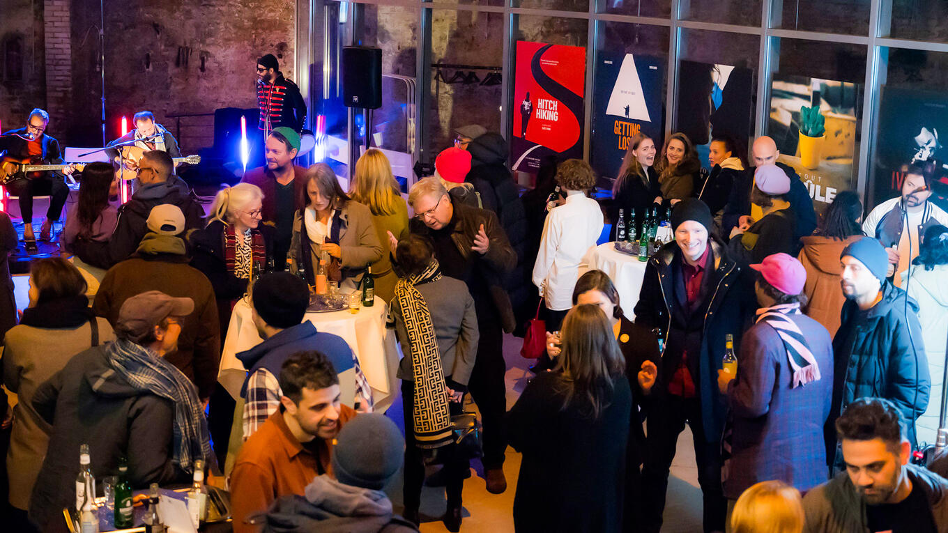 Post-screening gathering with audience and Idle Films team in relaxed atmosphere with live music.