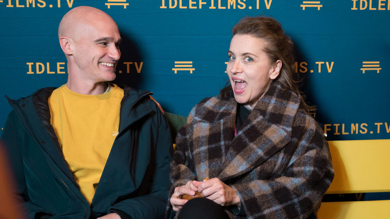 Ben Galliers, Marta Klaka, and Iliès Terki smiling together in front of the Idle Films step-and-repeat at the Hamburg premiere.