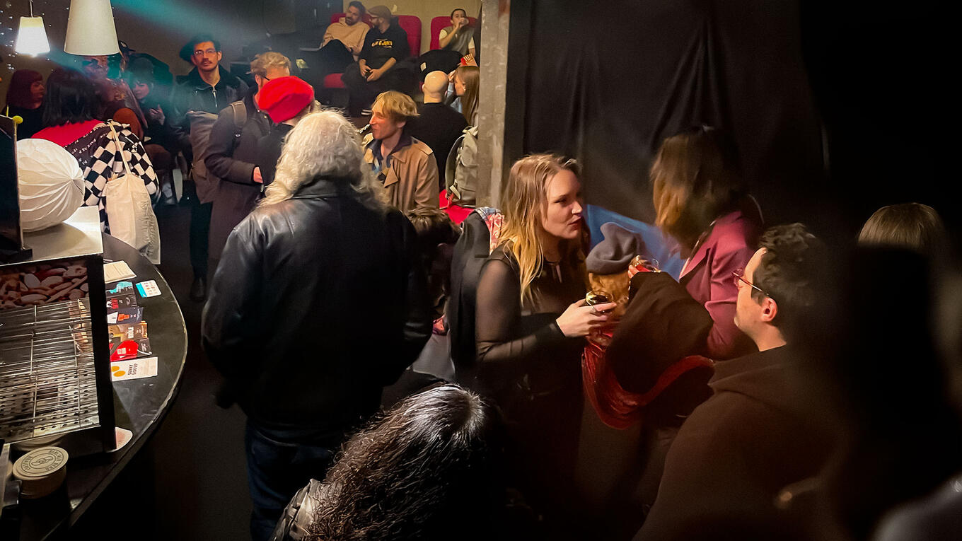 Busy cinema bar filled with guests and filmmakers mingling after the Berlin screening.