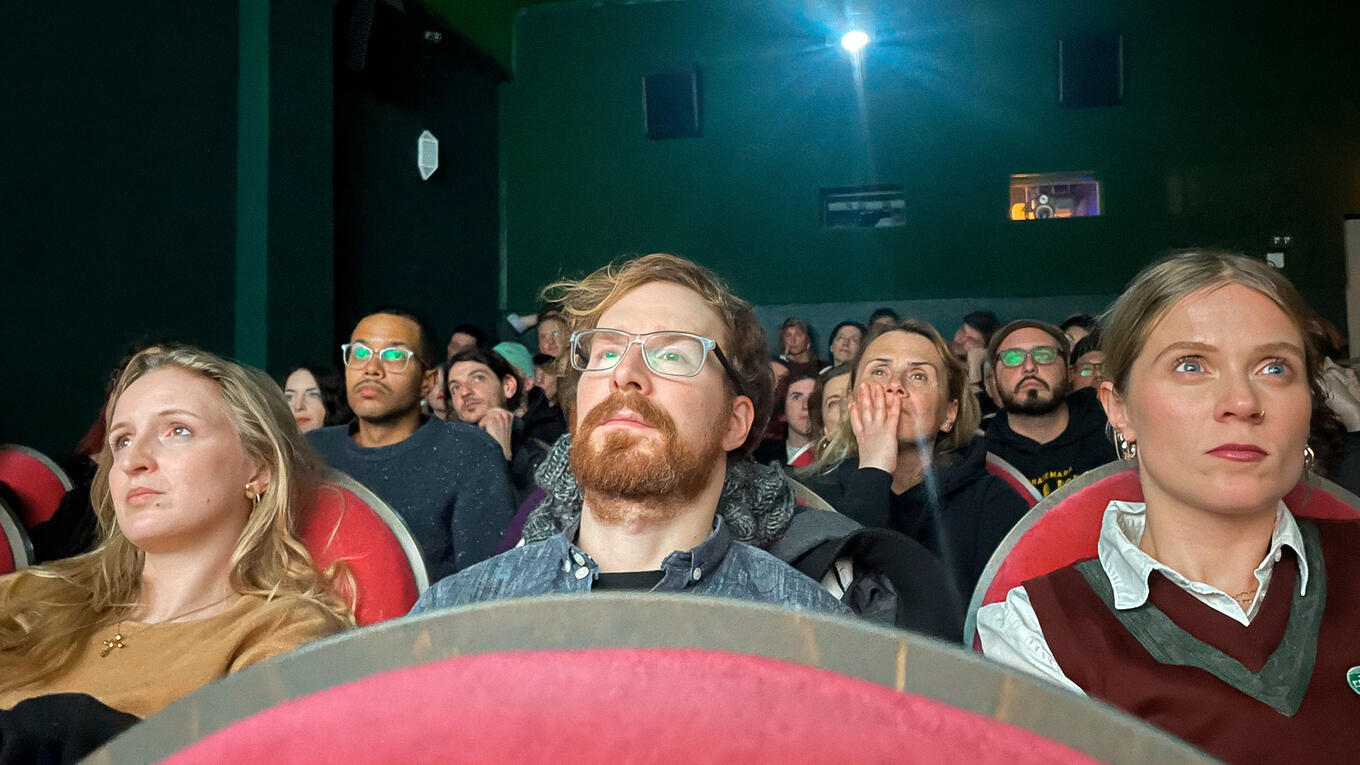 Close-up of audience members watching attentively during the Marseille premiere of Six Idle Shorts.